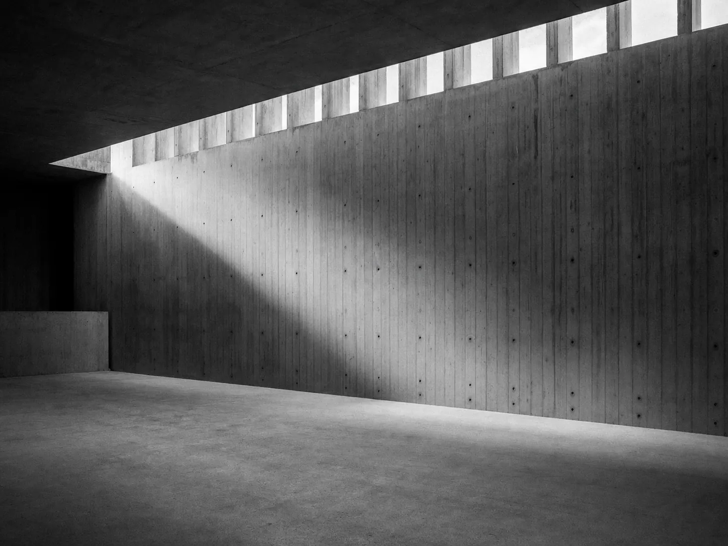 Empty concrete space with shafts of light