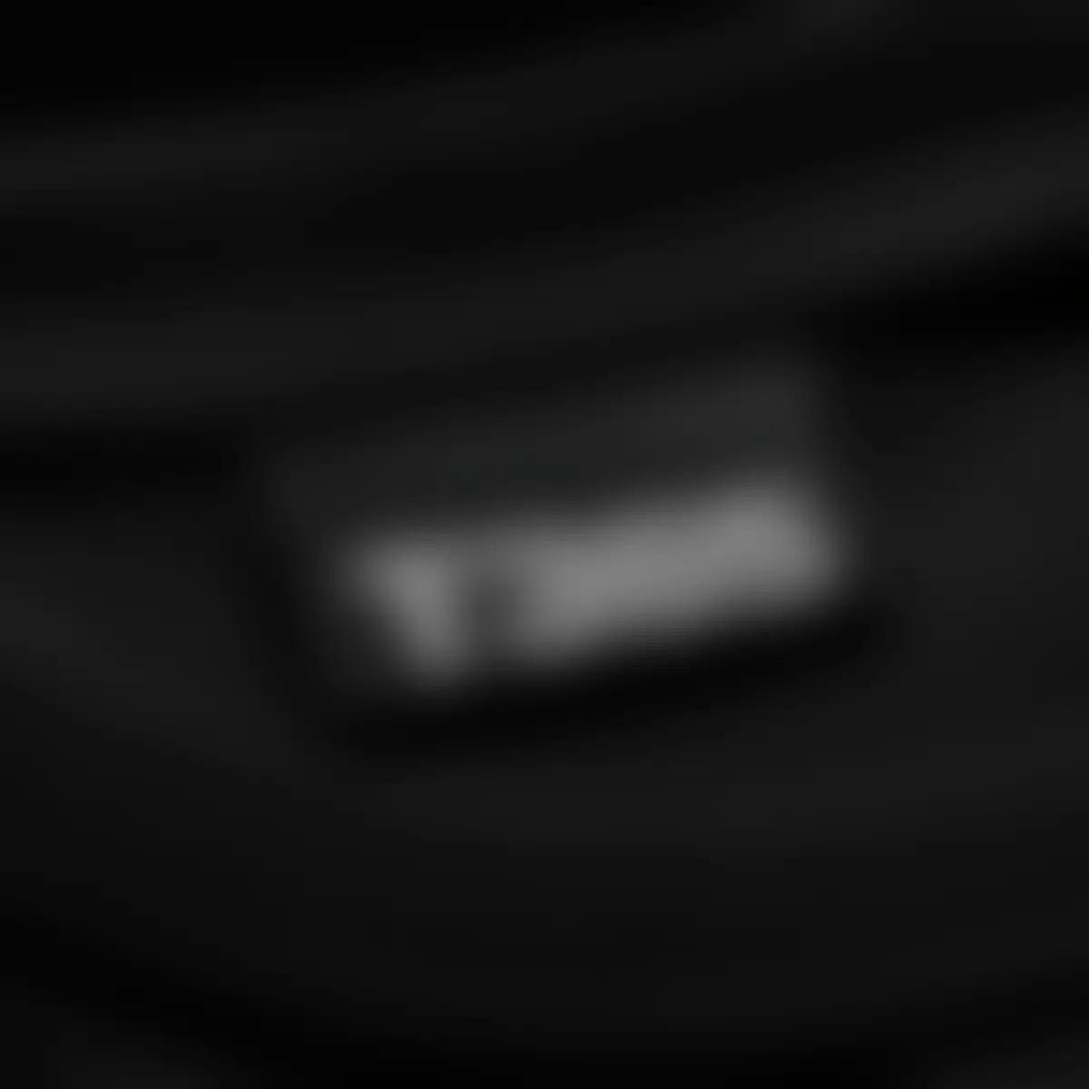 Woven T365 neck label stitched inside the collar in white on black satin